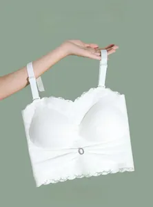 Detailed view of a white lace strapless bra with a bow knot and rhinestone ornament