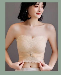 Close-up of floral lace strapless bra in beige with scalloped edges and crystal detail