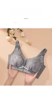 Detail of grey lace full cup bra showing floral embroidery and center bow decoration