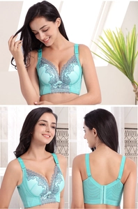 Detail view of mint green lace bra featuring side support wings and U-shaped back design