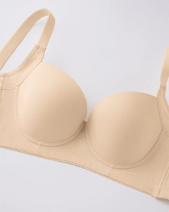Detail of seamless skin-tone bra featuring wide adjustable straps and smooth fabric