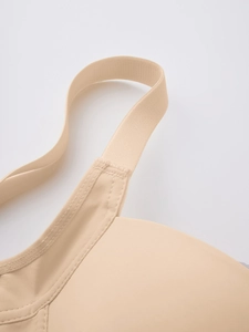 Close-up of seamless nude bra showing high-quality stitching and shoulder strap connection