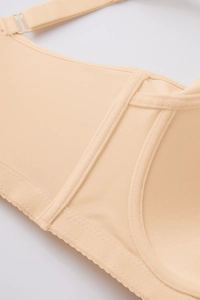 Detail of adjustable straps and seamless stitching on this beige memory wire bra