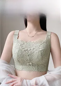 Close-up of light green lace bra showing floral texture and scalloped hem details