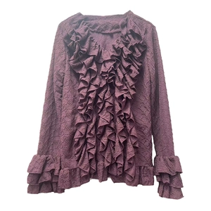 Detail of ruffled V-neckline on burgundy long sleeve shirt with textured jacquard fabric