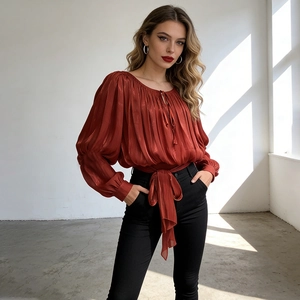 Detail of red-brown pleated satin blouse featuring tie-neck and lantern sleeves
