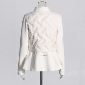 Detail of white slim-fit jacket showing quilted back panel and pleated peplum hemline
