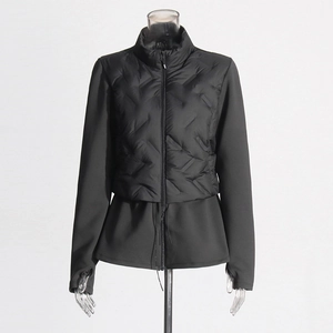Close-up of black quilted puffer jacket with mixed fabric panels and stand collar