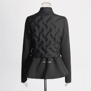 Detail of black sports jacket featuring wave quilted back and feminine peplum hem design