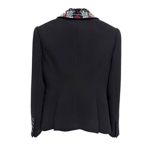 Detail of beaded collar and crystal embellishments on a black tailored blazer