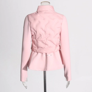 Detail view of pink quilted puffer jacket with reflective strip and wave stitching