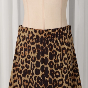 Macro detail of high-waisted elastic band on a leopard print midi skirt