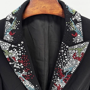 Detail of colorful rhinestones on the lapel of a stylish black women's suit blazer