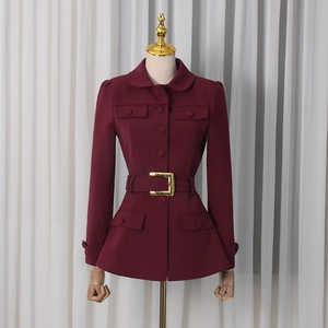 Detailed view of burgundy slim fit blazer with waist belt and gold buckle design