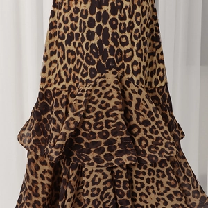 Detailed close-up of leopard print fabric layers and tiered ruffle design on the skirt