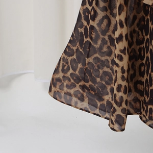 Close-up of leopard print chiffon skirt showing fabric texture and hem stitching detail