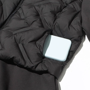 Detail of slim-fit down jacket with quilted fabric and hidden side zipper pocket