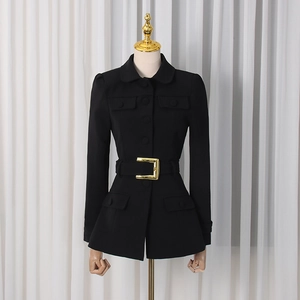 Detail of black blazer featuring a gold rectangular belt buckle and waist design