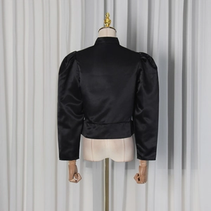 Detail view of the black satin jacket featuring puff sleeves and a high neck design