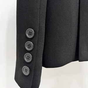 Detail of four black buttons on a premium woven suit sleeve with clean stitching