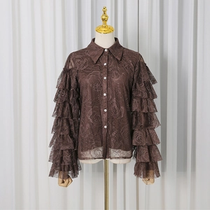 Detail of coffee lace shirt featuring rose patterns and multi-layered ruffled sleeves