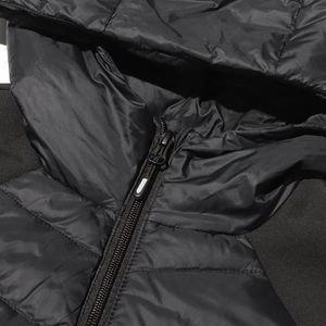 Detail of the hooded neckline and zipper of a black slim quilted puffer jacket