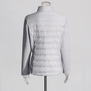 Detail of slim fit light gray quilted jacket with back stitching and mixed fabrics