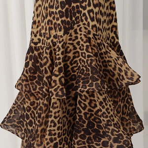 Detail of leopard print tiered skirt featuring layered ruffle hem and high waist flowy fabric