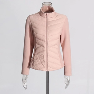 Detail of light pink quilted jacket featuring a stand collar and full zip closure
