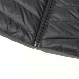 Close-up of black quilted down jacket featuring a resin zipper and detailed stitching