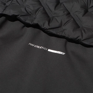 Macro detail of PERFATHLETICS logo on quilted black windproof jacket fabric