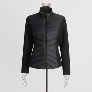Detail showing the slim-fit V-shaped quilted pattern and stand collar of a black jacket
