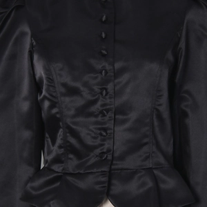 Detail of satin shirt showing matching fabric covered buttons and slim waist design