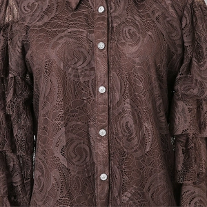 Detailed view of dark brown lace shirt with rose patterns and rhinestone buttons