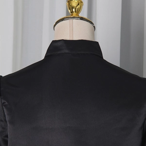 Close-up of the back stand-up collar and button detail on a black satin slim-fit shirt