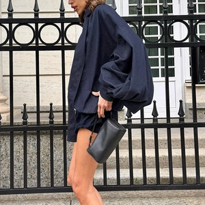 Close-up of a navy blue oversized shirt with lantern sleeves and matching shorts outfit