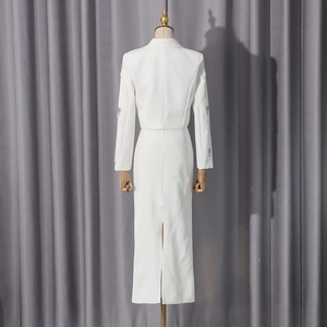 Detail of the back view of a white suit set with sequin embroidery on the cuffs