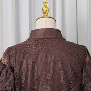 Detailed close-up of brown rose lace fabric on the collar and shoulder of this elegant top