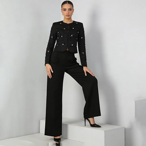 Detail of beaded floral embroidery and sequins on black tailored jacket for women