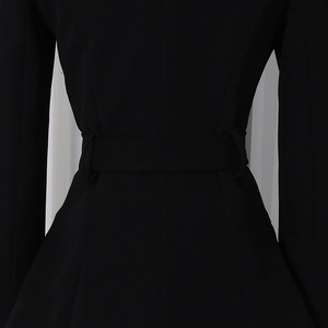 Detail view of the sleek waist belt and tailored stitching on this black blazer
