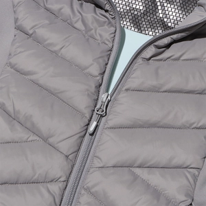 Detail of grey quilted jacket with resin zipper and silver heat-reflective lining