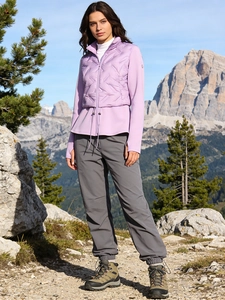 Slim fit light purple quilted down jacket with outdoor trekking pants against snowy mountains
