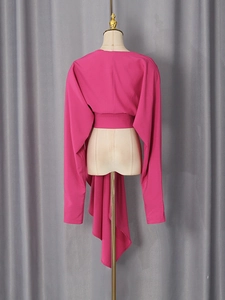 Magenta long sleeve V-neck top with an asymmetric draped hem and stylish back design