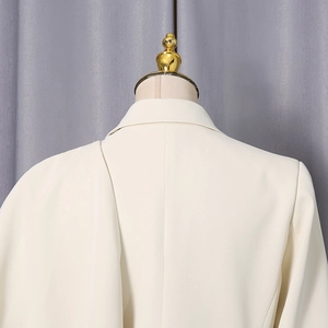 Close-up of cream white blazer back showing padded shoulders and sleek notched lapels