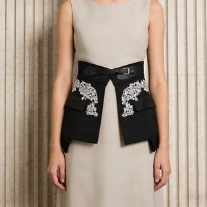 Detailed view of black waist corset with sparkling rhinestone flowers and belt closure