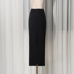 Detail view of high-waist black maxi skirt with an elegant back slit on a mannequin