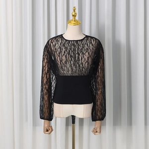 Detail of floral lace sleeves and slim-fit waist on this elegant black women's top