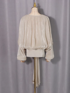 Elegant champagne pleated long sleeve blouse with tie-neck and silk-like finish
