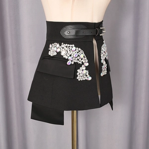 Detail of black A-line skirt with multi-color rhinestones and buckle belt detail