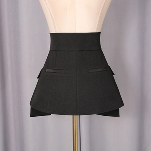 Detailed view of black A-line skirt featuring high waist, wide waistband and flap pockets